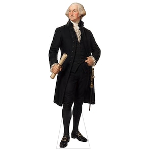 May include: A life-sized cardboard cutout of George Washington wearing a black coat, vest, and breeches with a white ruffled cravat and cuffs. He holds a rolled document in his right hand and has a sword hanging at his left side.