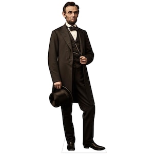 May include: A life-sized cardboard cutout of Abraham Lincoln wearing a black frock coat, matching trousers, a dark vest with a gold pocket watch chain, a white shirt, and a black bowtie. He holds a black top hat in his right hand.