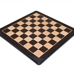 May include: A wooden chessboard with a black and brown checkered pattern. The board has a dark brown border.