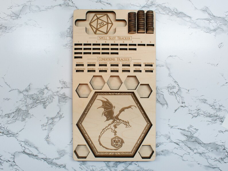 May include: Wooden game board with a dragon design, a 20-sided die, and a spell slot tracker. The board also includes a conditions tracker with labels for blinded, charmed, deafened, frightened, grappled, incapacitated,  inured, invisible, paralyzed, petrified, poisoned, prone, restrained, and stunned.
