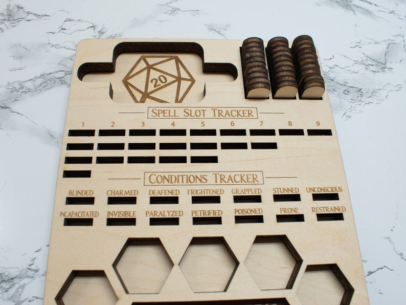 May include: Wooden game board with a 20-sided die, spell slot tracker, and condition tracker. The board has slots for tokens and is engraved with the words "SPELL SLOT TRACKER" and "CONDITIONS TRACKER".