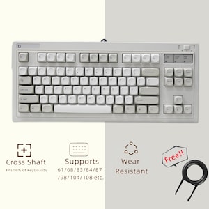 May include: A light gray mechanical keyboard with white keycaps. The keyboard has a standard layout with function keys, a number pad, and arrow keys. Features include cross shaft compatibility, wear resistance, and support for various keyboard sizes. A keycap puller is included.