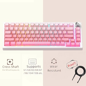 May include: A white mechanical keyboard with pink keycaps and a silver volume knob. The keycaps have a gradient color scheme. The keyboard supports various layouts and is wear-resistant. Includes a keycap puller.