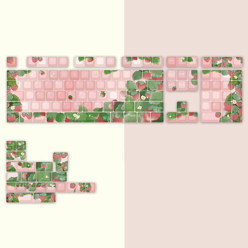 May include: A set of pink and white keyboard keycaps with a strawberry and leaf design. The keycaps are arranged in a keyboard layout with the function keys, number keys, and letter keys visible.