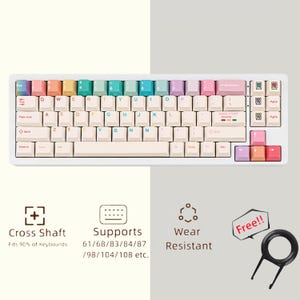 以下が含まれることがあります： パステルカラーのキーキャップが付いた白いメカニカルキーボード。キーボードはコンパクトなレイアウトで、キーキャッププーラーが含まれています。キーボードのテキストには「Cross Shaft」、「Supports」、「Wear Resistant」が含まれています。