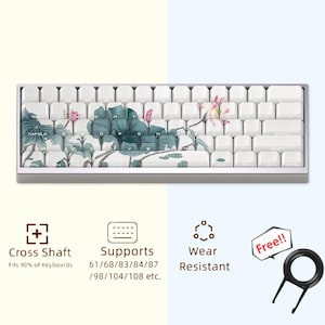 May include: White mechanical keyboard with a floral design featuring lotus flowers and leaves. The keyboard has a cross shaft design and supports 61, 68, 83, 84, 87, 98, 104, and 108 key layouts. It is wear resistant and comes with a keycap puller.