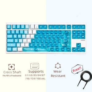 Pode incluir: Um teclado mecânico branco e azul com teclas azuis transparentes. As teclas têm vários símbolos e ícones. O teclado suporta 61/68/83/84/87/98/104/108 teclas. Um extrator de teclas também é visível.