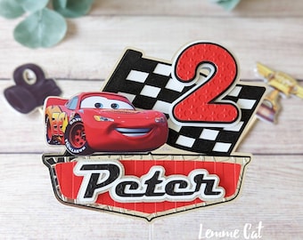 May include: Red Lightning McQueen car cake topper with a checkered flag, the number 2, and the name Peter.