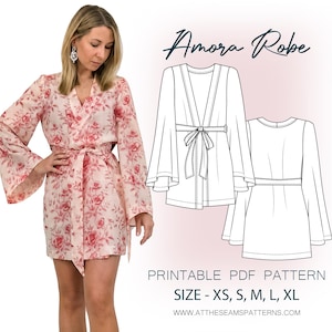 May include: A short robe with a pink and red floral pattern, featuring wide sleeves and a waist tie. Next to it is a black and white line drawing of the Amora Robe, labeled Printable PDF Pattern, Size - XS, S, M, L, XL, www.attheseamspatterns.com.