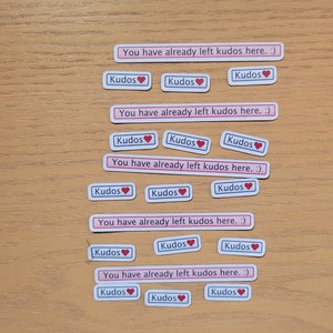 May include: A set of 15 stickers with the text "You have already left kudos here. :)" and "Kudos" with a red heart. The stickers are on a wooden surface.
