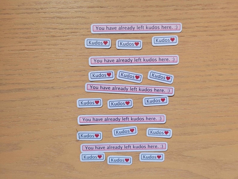 May include: A set of 15 stickers with the text "You have already left kudos here. :)" and "Kudos" with a red heart. The stickers are on a wooden surface.