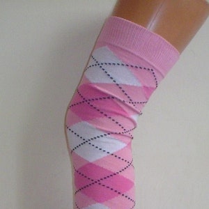 May include: Pink and white argyle knee-high socks with black stitching.