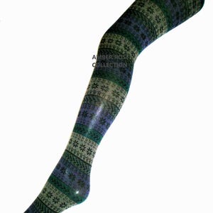 May include: A patterned stocking in shades of green and blue, with a repeating snowflake design. The text "AMBER ROSE COLLECTION" is visible on the stocking. The stocking is displayed on a mannequin leg.