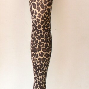May include: A pair of brown and tan leopard print tights on a mannequin.