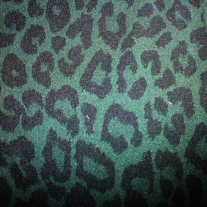 May include: A fabric featuring a dark forest green background with a repeating black leopard print pattern. The texture of the material appears soft and slightly fuzzy, with the dark spots distributed evenly across the surface of the textile.