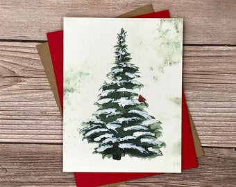 May include: A watercolor painting of a snow-covered evergreen tree with a red cardinal perched on a branch. The background is a soft green watercolor wash.