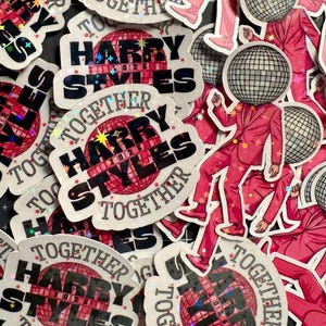 May include: A collection of stickers and illustrations featuring the text "HARRY STYLES TOGETHER 2026". The stickers have a disco ball design and a figure in a pink suit with a disco ball head.