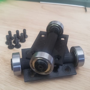 May include: A set of black plastic caster wheels with silver metal bearings. The wheels are mounted on a black plastic base with screw holes. The set includes a bag of black screws.