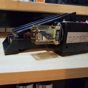 May include: A black foot pedal with a clear plastic housing and a label that reads "SIGNAL". The pedal has a side switch and a series of markings for "SIDE", "MM", "PN", "SIDE", "MM", and "PN".