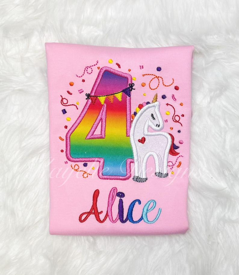May include: Pink t-shirt with a rainbow number four and a white unicorn with a pink heart. The shirt says "Alice" in rainbow letters.