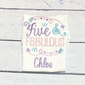 Pode incluir: Camiseta branca com bordado rosa e roxo que diz "Five & Fabulous" com um design decorativo e o nome "Chloe" bordado abaixo.