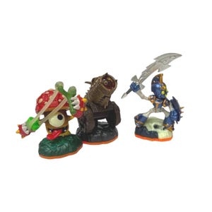 May include: Three Skylanders figures: a green and red mushroom character with a slingshot, a brown cannon character, and a blue and silver knight character with a sword.