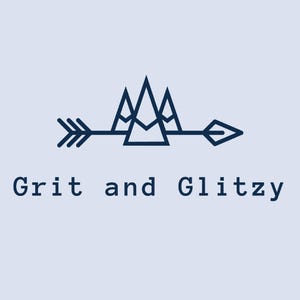 May include: A navy blue logo with the text "Grit and Glitzy" below a dark blue arrow and mountain range design. The arrow points right, and the mountains are composed of three triangular peaks.