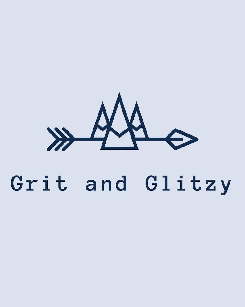 May include: A navy blue logo with the text "Grit and Glitzy" below a dark blue arrow and mountain range design. The arrow points right, and the mountains are composed of three triangular peaks.
