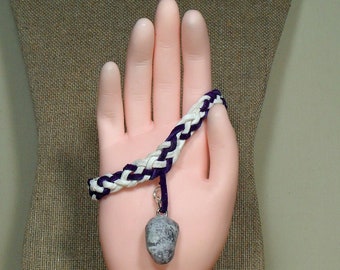 Woven purple and white bracelet with flecks that sparkle.