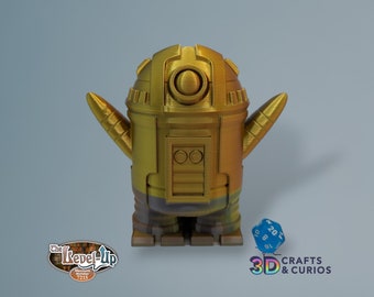 May include: A gold-colored robot figurine with a rounded head and two small arms. The robot has a textured surface and a metallic sheen. The robot is standing on a flat surface.