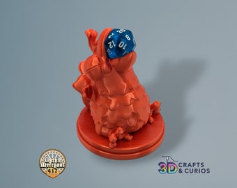 May include: Orange 3D printed miniature of a creature holding a blue 20-sided die.