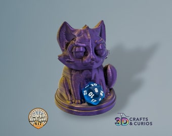 May include: Purple and gold 3D printed cat figurine holding a blue 20-sided dice. The cat has a grumpy expression and is sitting on a round base.
