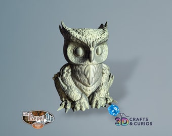 May include: A 3D printed owl figurine with a gray and white color scheme. The owl is sitting on a gray surface with a blue and white dice in front of it. The owl has a detailed design with sharp claws and a textured surface. The owl is a popular fantasy creature and is often used in role-playing games.