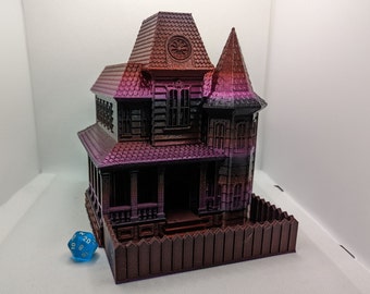 May include: A 3D printed model of a haunted house with a dark red and purple color scheme. The house has a pointed roof, a fence, and a small window with a circular design. A blue 20-sided die is in the foreground.