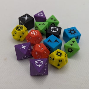 May include: A collection of 12 colorful dice with various symbols and designs. The dice are made of plastic and are in a variety of colors, including red, blue, green, yellow, purple, and black.