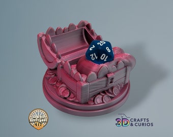 May include: A 3D printed, pink, treasure chest shaped dice holder with a blue 20-sided die resting on top. The chest is decorated with gold coins and has a hinged lid.