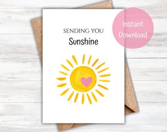 May include: A white greeting card with the words "Sending You Sunshine" and a watercolor sun illustration with a pink heart. The card is on a brown envelope, with a pink circle that says "Instant Download".