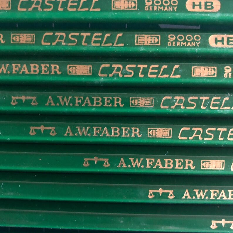 May include: Close-up of several green pencils with gold lettering. The pencils have the words "CASTELL" and "A.W. FABER" printed on them. The pencils are labeled "GERMANY" and "HB".