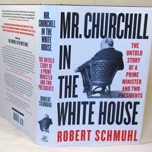 May include: A hardback book titled "Mr. Churchill in the White House" by Robert Schmuhl. The cover displays a black and white image of a man in a chair, with the title in large black and red text. The book's spine is visible.