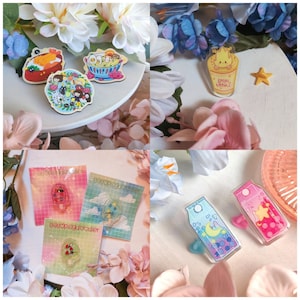 May include: A collection of enamel pins featuring various food-themed designs. The pins are colorful and feature cartoon-like characters. Some of the designs include a bowl of ramen noodles, a cup of instant noodles, a popsicle, a milk carton, and a plate of rice with a fried egg.