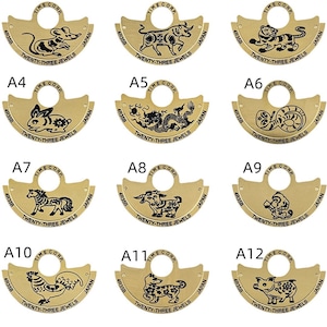 May include: Twelve gold-colored metal watch face covers with different Chinese zodiac animal designs. Each cover has the text "TIME CORP" and "TWENTY-THREE JEWELS" printed on it.