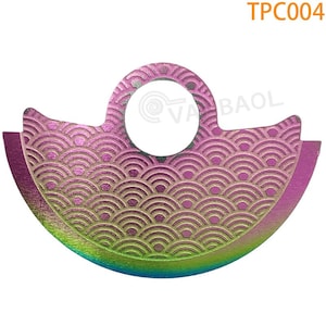 May include: A colorful metal disc with a wave pattern and a hole in the center. The disc is a vibrant pink, green, and blue.