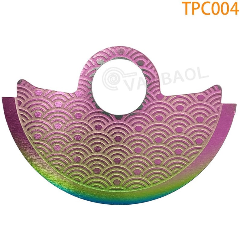 May include: A colorful metal disc with a wave pattern and a hole in the center. The disc is a vibrant pink, green, and blue.