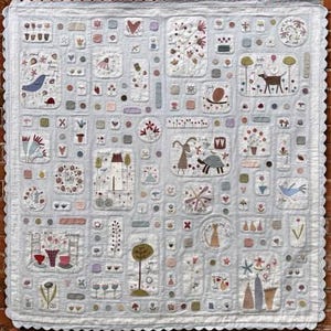 May include: A patchwork quilt with a light blue background and various colorful embroidered designs. The quilt features a variety of motifs, including birds, flowers, houses, and animals. The quilt is made with a variety of fabrics and textures, and the stitching is intricate and detailed.