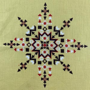 May include: A geometric starburst pattern in black, red, and white on a pale yellow background. The design features arrows, squares, and triangles arranged in a symmetrical pattern, creating a striking visual effect. The overall theme is a decorative textile design.