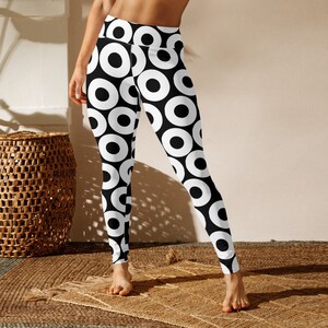 May include: Black and white leggings with a geometric pattern of white circles on a black background.