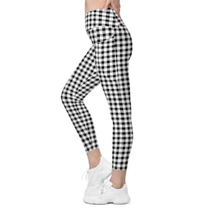 May include: Black and white gingham leggings with a large side pocket. The leggings are fitted and have a high waist.
