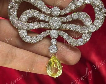 Spilla vintage a forma di fiocco in stile Maria Antonietta, con diamanti e zaffiro giallo, in argento sterling.