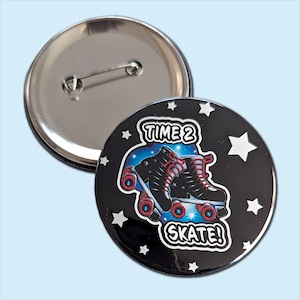 May include: A round pinback button featuring a black background with white stars and a central graphic of black roller skates with red laces and wheels. The text "TIME 2 SKATE!" is printed in white with a black outline. The back shows a metal pin.