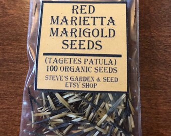 May include: A clear plastic bag filled with 100 organic red marigold seeds, labeled "Red Marietta Marigold Seeds (Tagetes Patula)" and "Steve's Garden & Seed Etsy Shop".